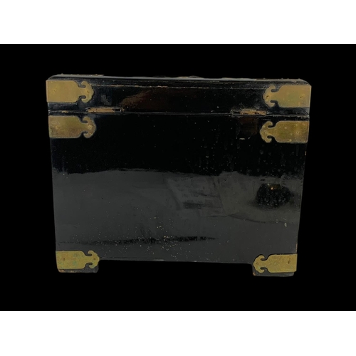 28 - An oriental style brass bound lacquered jewellery box faux ivory. 32 x 21 x 25cm.