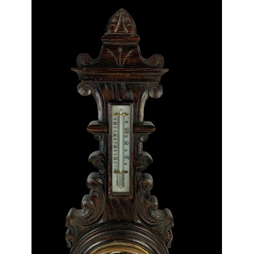 30 - A late Victorian carved oak barometer 68cm.