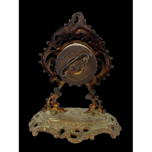 33 - A 19th century ornate brass wind up clock. Circa 1880. 18 x 20cm.