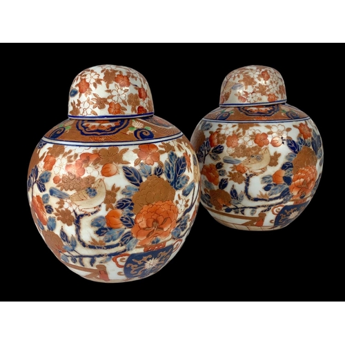 393 - A pair of large 19th century Japanese pottery ginger jars with lids. 18 x 18cm.