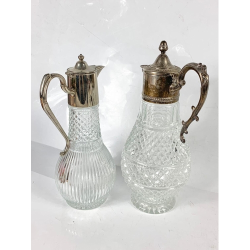 421 - 2 vintage silver plated claret jugs. Largest 32cm.