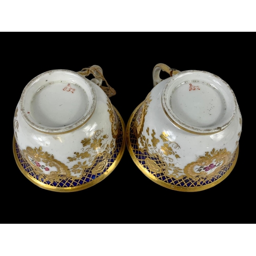 460 - A pair of early 19th century porcelain tea cups. Number 2/252. Circa 1805-1820.