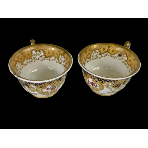 460 - A pair of early 19th century porcelain tea cups. Number 2/252. Circa 1805-1820.