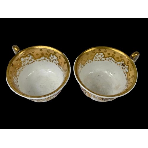 460 - A pair of early 19th century porcelain tea cups. Number 2/252. Circa 1805-1820.