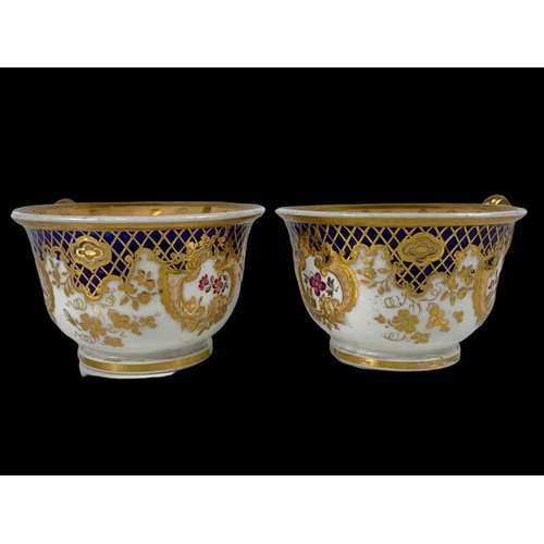 460 - A pair of early 19th century porcelain tea cups. Number 2/252. Circa 1805-1820.