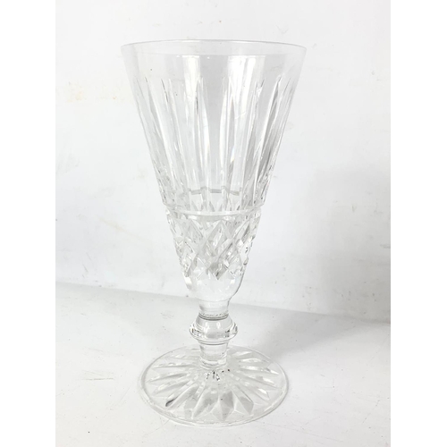 493 - A set of 9 Waterford crystal Tramore flute champagne glasses. 16cm.