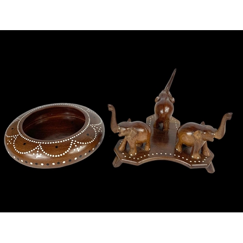 64 - An inlaid Indian hardwood centrepiece bowl on stand with elegant decoration. 21 x 15cm.