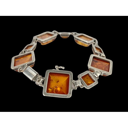 660 - A vintage silver and amber bracelet.