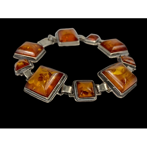 660 - A vintage silver and amber bracelet.