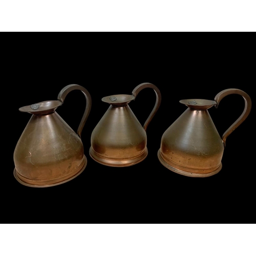 69 - A set of 3 Victorian copper jugs. 25 x 25cm.