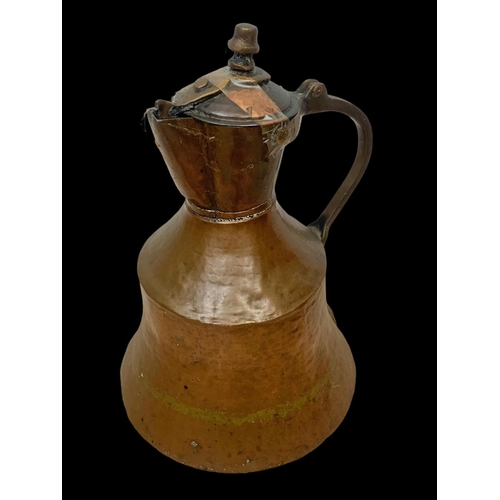 70 - 3 large early 20th century Middle Eastern copper pitchers largest 41cm