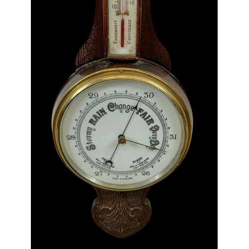 72 - An Edwardian carved oak barometer. 81cm.