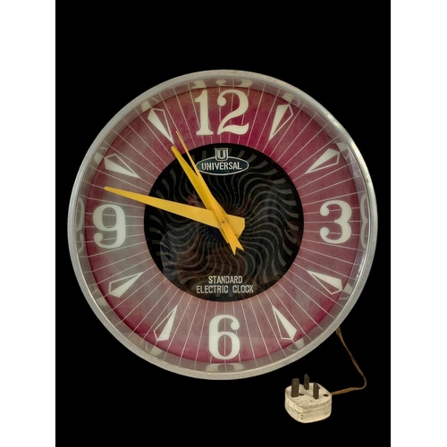 78 - A large vintage Universal electric wall clock. 39.5cm.