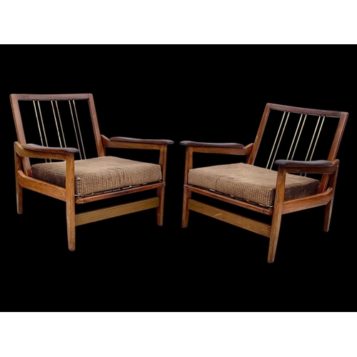 818 - A pair of teak armchairs with brass back rails and cushions. Mid century. Circa 1960’s. 72 x 65 x 70... 