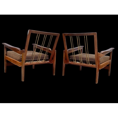 818 - A pair of teak armchairs with brass back rails and cushions. Mid century. Circa 1960’s. 72 x 65 x 70... 