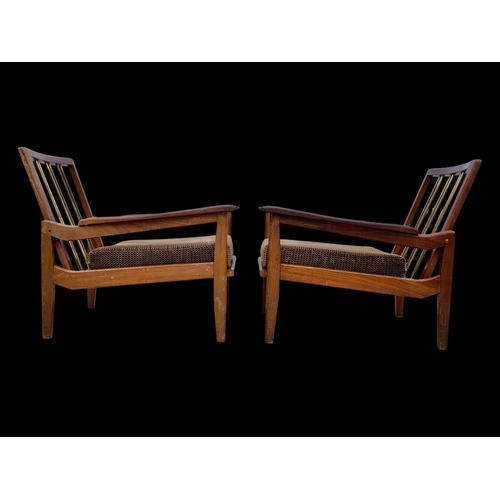 818 - A pair of teak armchairs with brass back rails and cushions. Mid century. Circa 1960’s. 72 x 65 x 70... 