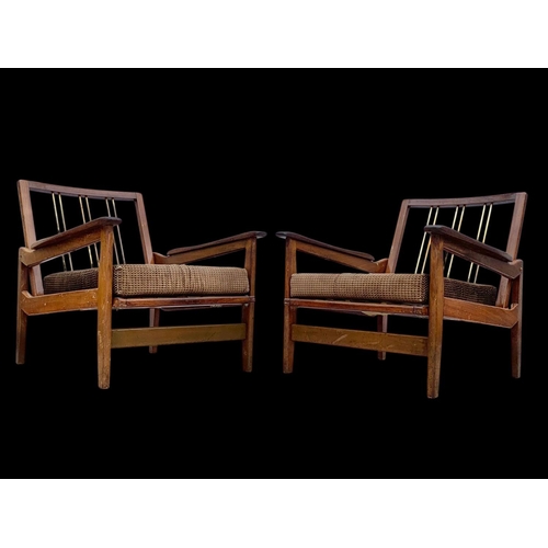 818 - A pair of teak armchairs with brass back rails and cushions. Mid century. Circa 1960’s. 72 x 65 x 70... 