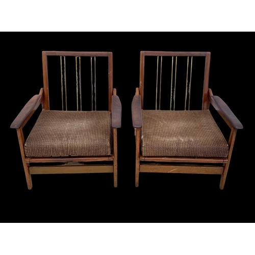 818 - A pair of teak armchairs with brass back rails and cushions. Mid century. Circa 1960’s. 72 x 65 x 70... 