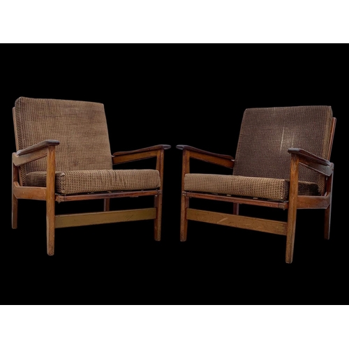 818 - A pair of teak armchairs with brass back rails and cushions. Mid century. Circa 1960’s. 72 x 65 x 70... 