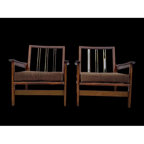 818 - A pair of teak armchairs with brass back rails and cushions. Mid century. Circa 1960’s. 72 x 65 x 70... 