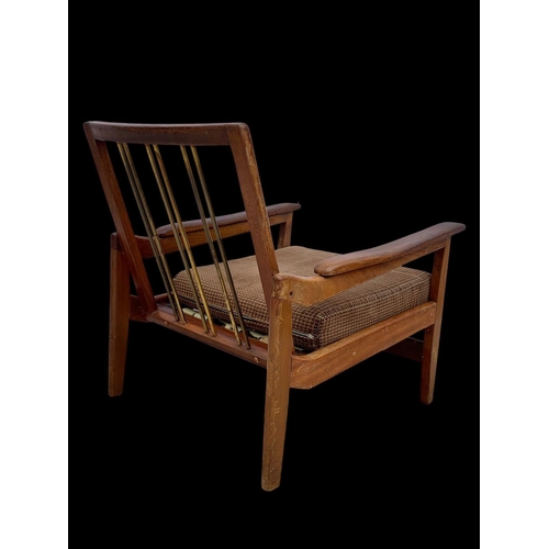 818 - A pair of teak armchairs with brass back rails and cushions. Mid century. Circa 1960’s. 72 x 65 x 70... 