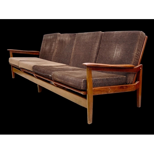 819 - A long teak 4 seater sofa with brass back rails and cushions. Mid century. Circa 1960’s. 230cm.