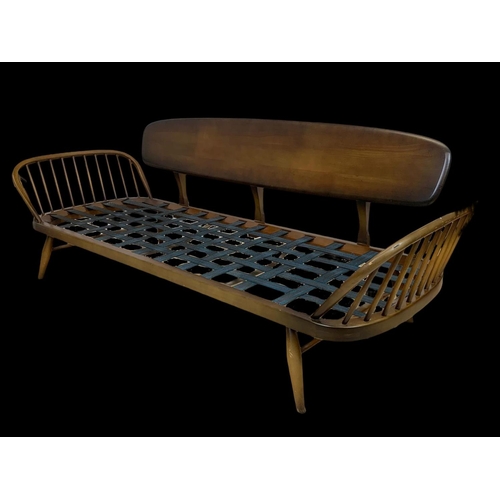 822 - An Ercol Elm Model 355 Studio Daybed. Mid century. Circa 1960. 211cm.