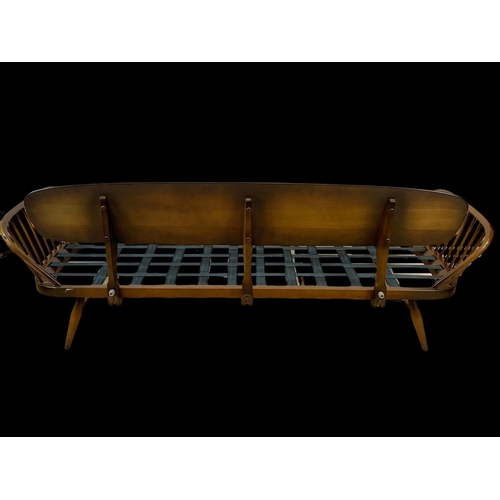 822 - An Ercol Elm Model 355 Studio Daybed. Mid century. Circa 1960. 211cm.