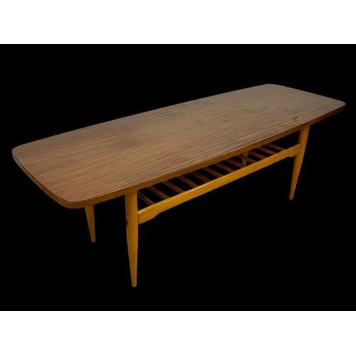 842 - A walnut and beech coffee table with under storage. Mid century. Circa 1960. 137 x 50 x 46cm.