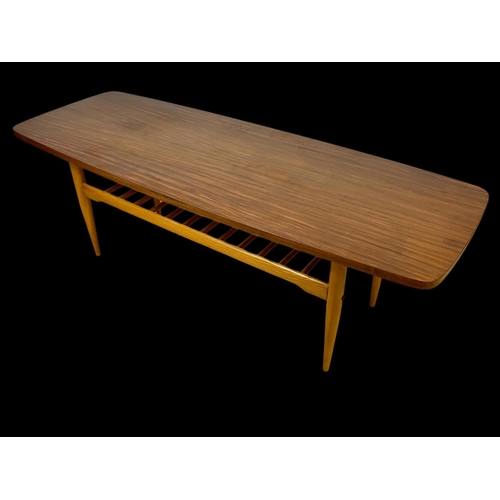 842 - A walnut and beech coffee table with under storage. Mid century. Circa 1960. 137 x 50 x 46cm.