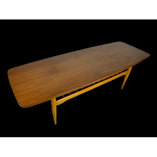 842 - A walnut and beech coffee table with under storage. Mid century. Circa 1960. 137 x 50 x 46cm.