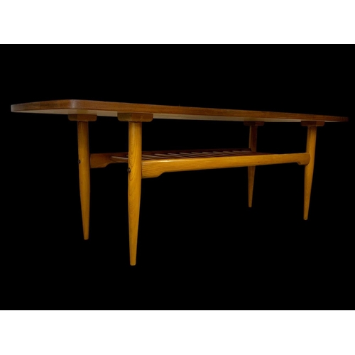 842 - A walnut and beech coffee table with under storage. Mid century. Circa 1960. 137 x 50 x 46cm.