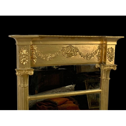 864 - An early 19th century Regency gilt framed mirror. 56.5 x 101cm.