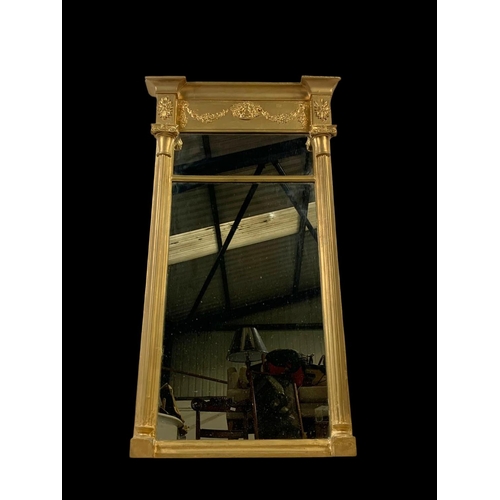 864 - An early 19th century Regency gilt framed mirror. 56.5 x 101cm.