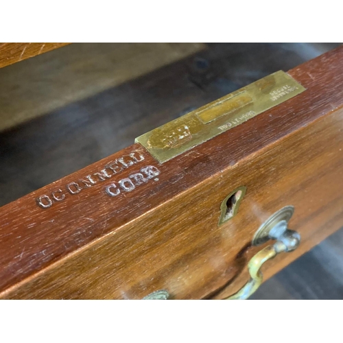 865 - A tall Edwardian mahogany office chest of drawers with brass drop handles. Stamped O’Connell Cork. 5... 