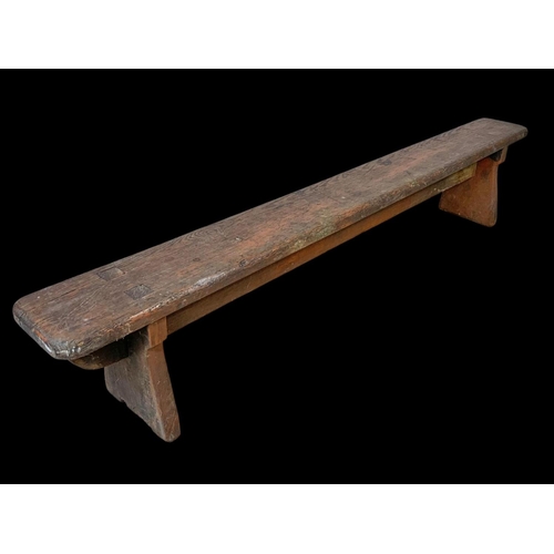 872 - A long early 20th century pitch pine stool/bench. Circa 1900. 154 x 18 x 30cm