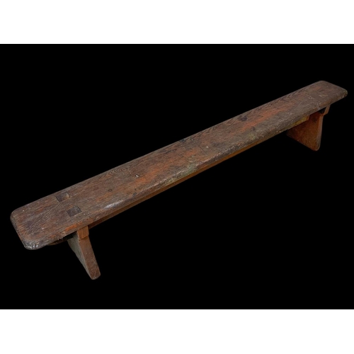 872 - A long early 20th century pitch pine stool/bench. Circa 1900. 154 x 18 x 30cm