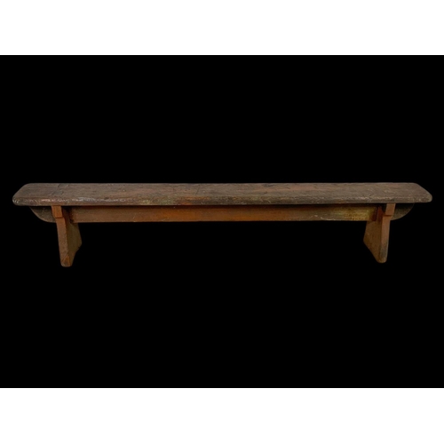 872 - A long early 20th century pitch pine stool/bench. Circa 1900. 154 x 18 x 30cm