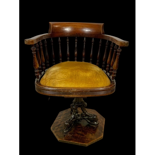 874 - An Edwardian mahogany ship’s captains chair stamped Arch Stewart & Co. with a cast iron base.