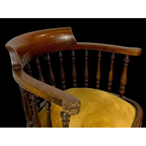 874 - An Edwardian mahogany ship’s captains chair stamped Arch Stewart & Co. with a cast iron base.