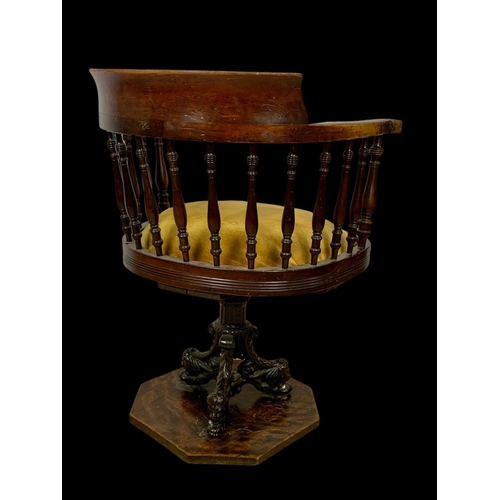 874 - An Edwardian mahogany ship’s captains chair stamped Arch Stewart & Co. with a cast iron base.