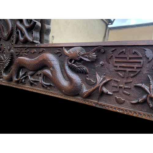 884 - A large 19th century Chinese carved framed mirror. Circa 1880. 137 x 103cm.