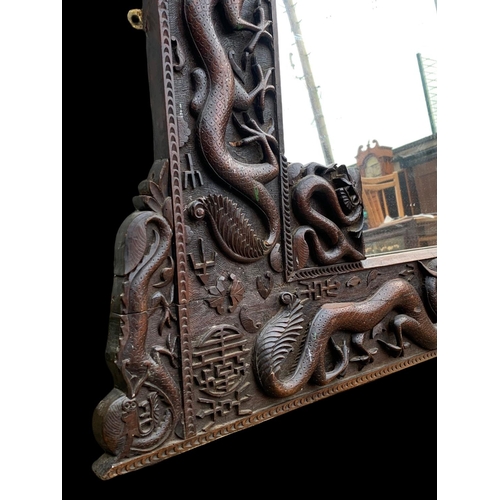 884 - A large 19th century Chinese carved framed mirror. Circa 1880. 137 x 103cm.