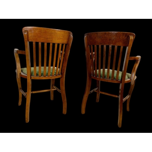 886 - A pair of Edwardian oak desk armchairs.