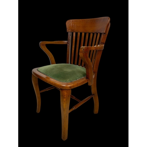 886 - A pair of Edwardian oak desk armchairs.