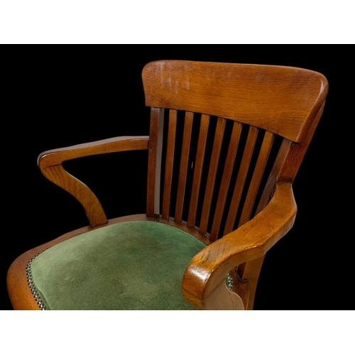 886 - A pair of Edwardian oak desk armchairs.