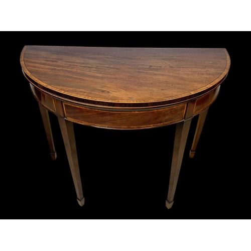 891 - A Georgian Sheraton inlaid mahogany turnover games table with satinwood cross banding. 96.5 x 48 x 7... 