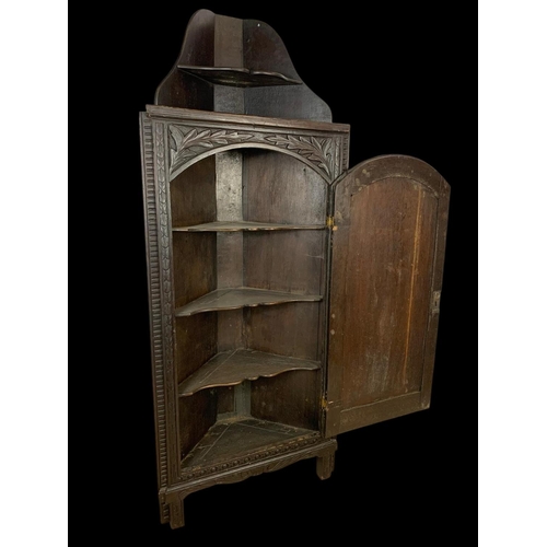 899 - A late Victorian carved oak corner cabinet. 17th century style. 68 x 40 x 166cm