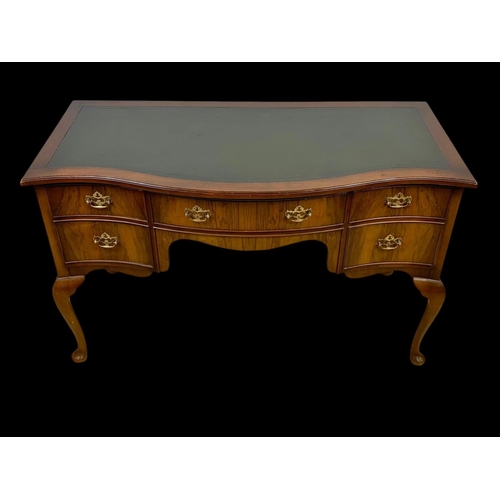 906 - A vintage walnut leather top writing desk. Circa 1950. 124 x 60 x 76.5cm