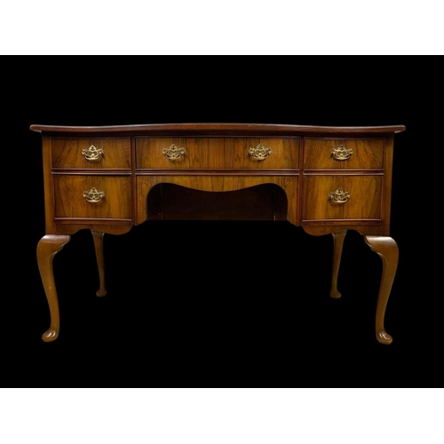 906 - A vintage walnut leather top writing desk. Circa 1950. 124 x 60 x 76.5cm